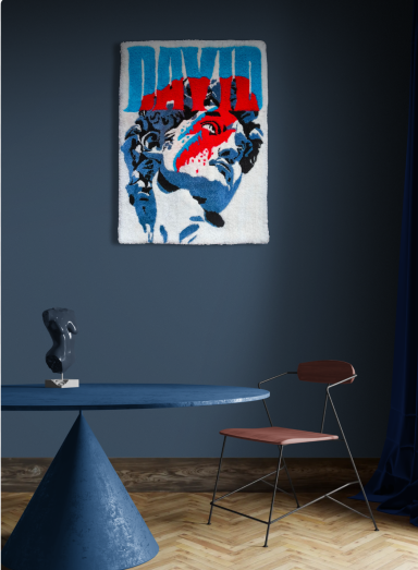 Abstract artwork featuring a hand and figure against a dark blue wall, with a minimalistic table and chair.